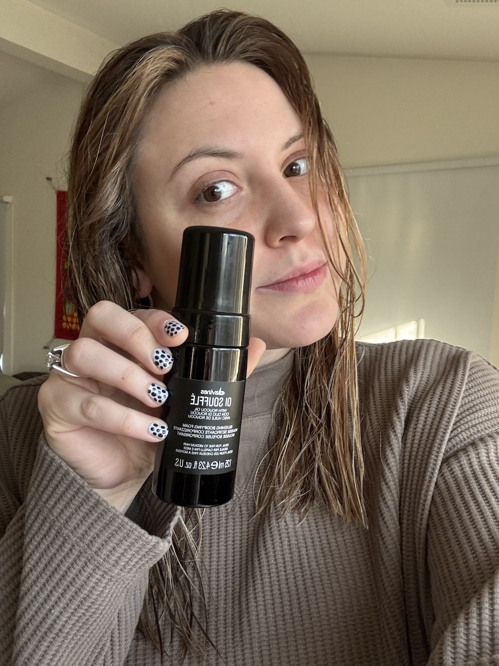 Sophia Vilensky with a bottle of Oi Souffl&eacute; mousse by Davines.