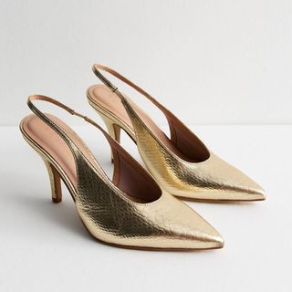 A cut of New Look gold heeled slingback shoes on a white background