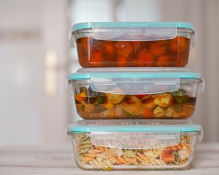 Hermetic glass containers of cooked food piled up in a kitchen