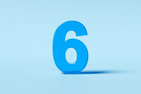 Translucent number six standing on a light blue background
