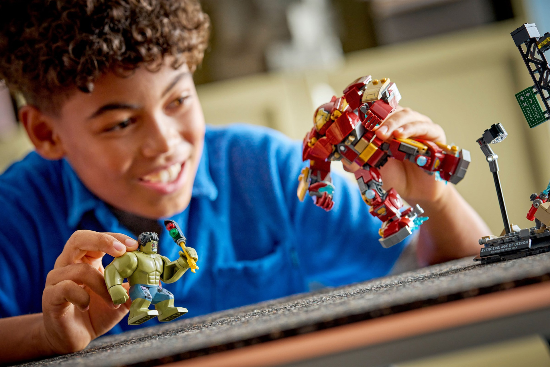 A Lego Epic Battle: Hulkbuster vs. The Hulk set, with a boy making the Hulk fight the Hulkbuster.
