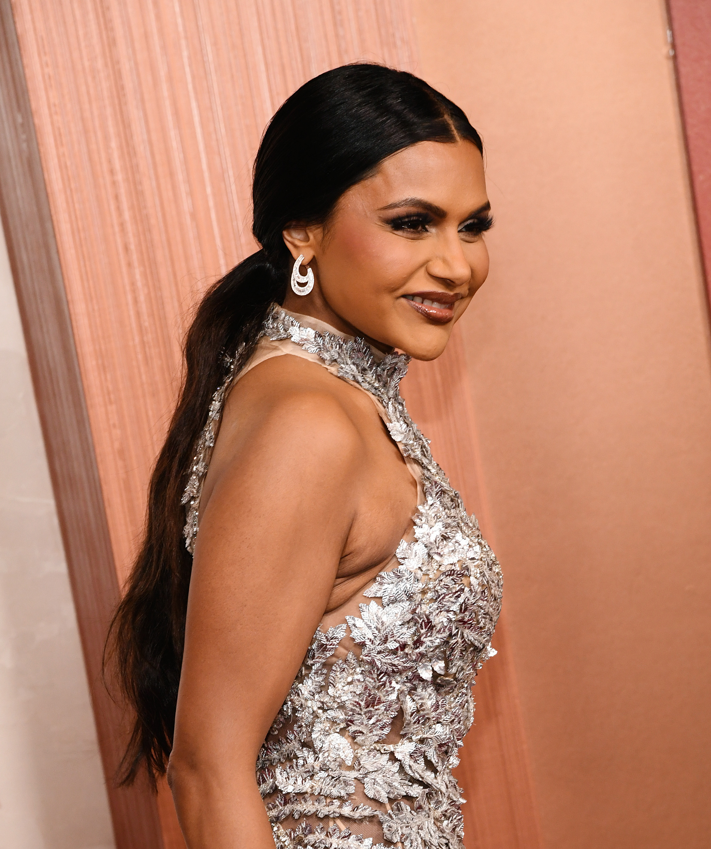 mindy kaling with a sleek low ponytail