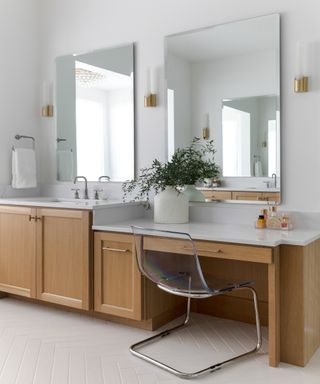 Bathroom vanity seating area with wooden cabinets and a marble top