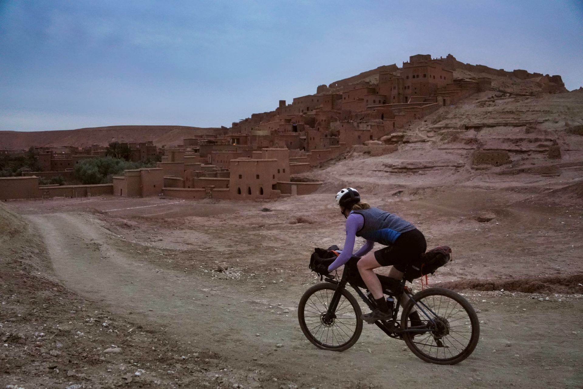 Image shows cyclist riding gravel bike