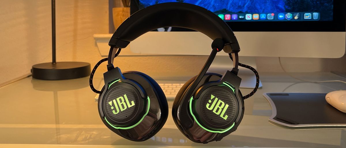 A JBL Quantum 810 Wireless gaming headset on a desk