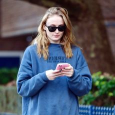 Sophie Turner wears a Taylor Swift eras tour sweatshirt while walking around new york city with sweatpants and adidas sneakers