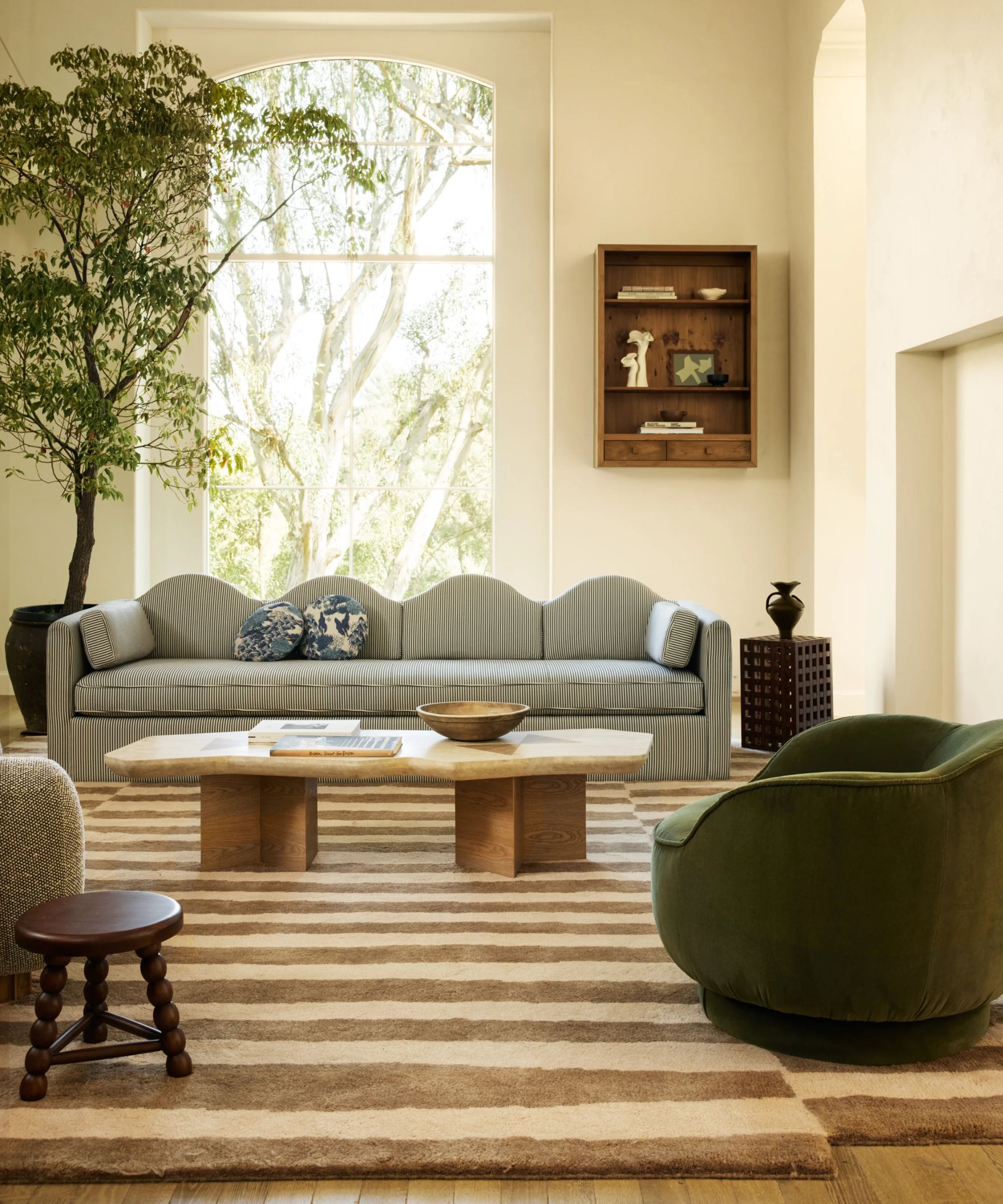 modern living room designed by sarah sherman samuel for lulu and georgia with a striped curvy couch