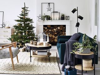 White living room with a feature fireplace decorated for Christmas