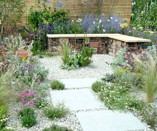 gravel patio with wildlife garden bench and natural planting