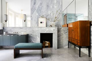Bathroom with blue-tinted marble-clad wall and fireplace