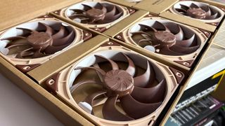 The Antec Flux Pro Noctua Edition on a desk with various parts disassembled.