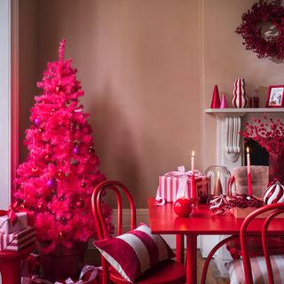 pink christmas tree and decorations with a dining table