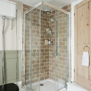 bathroom with shower and brick tiles