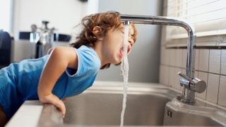 boy drinks from tap