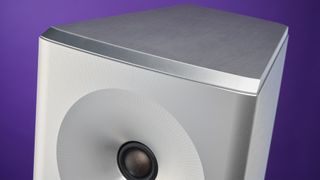 YG Acoustics Carmel 3 floorstanding speakers close up on top of speaker against purple backdrop