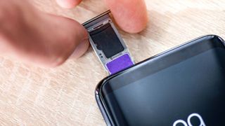 microsd card being inserted into phone sim card tray