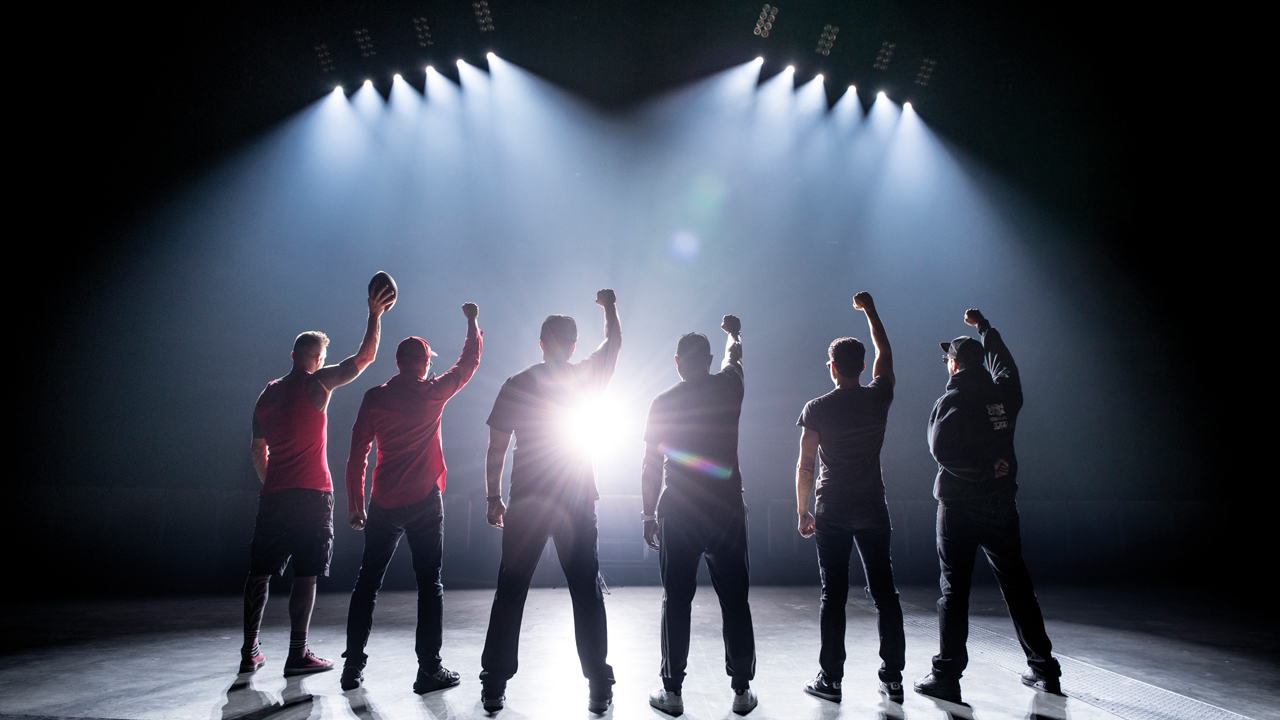 A photograph of Prophets Of Rage all stood with their fists in the air