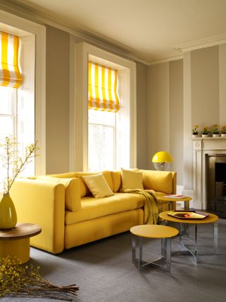 Yellow living room with yellow sofa and striped curtains