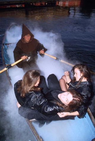 Meat Loaf being rowed into the launch party for Bat Out Of Hell II: Back Into Hell, with two young women