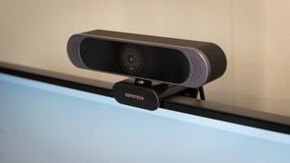 Depstech DW49 Pro 4K webcam mounted on top of a PC monitor