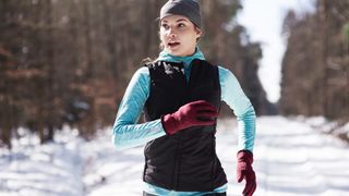 female runner in snow
