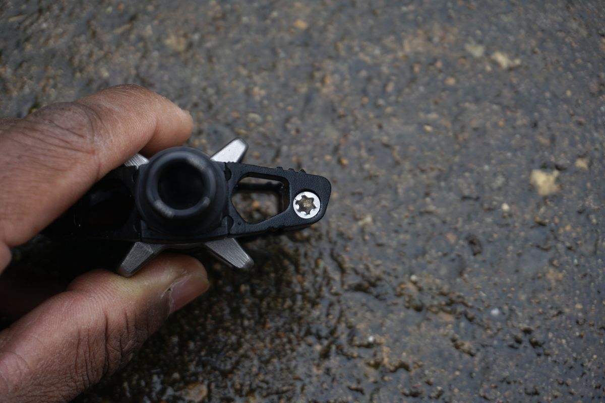 The axle of a black gravel bike pedal