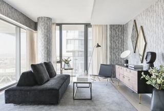 Modern apartment grey living room with dark grey sofa