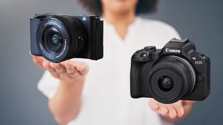 Two cameras held in palm of hands. 