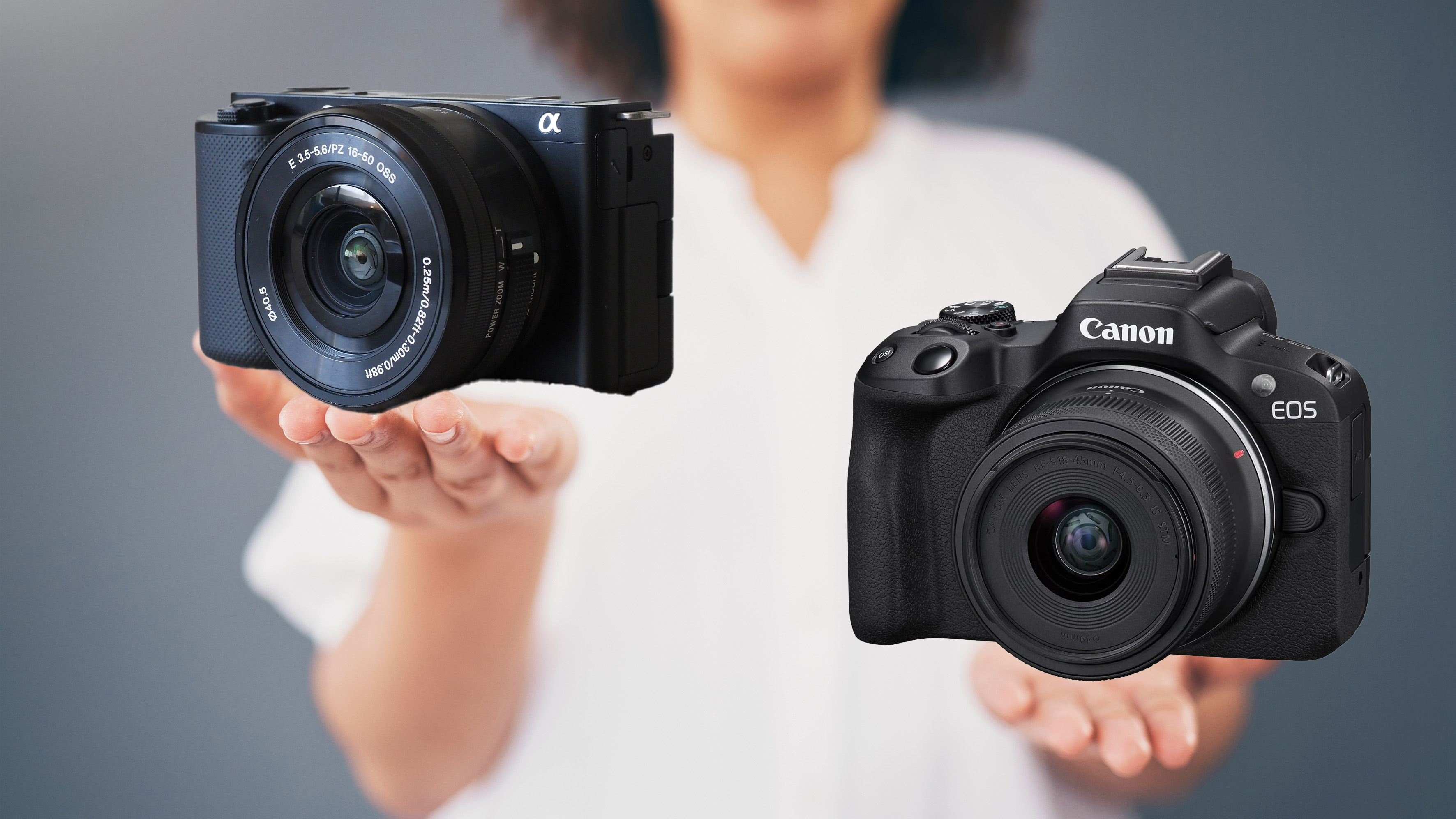 Two cameras held in palm of hands.