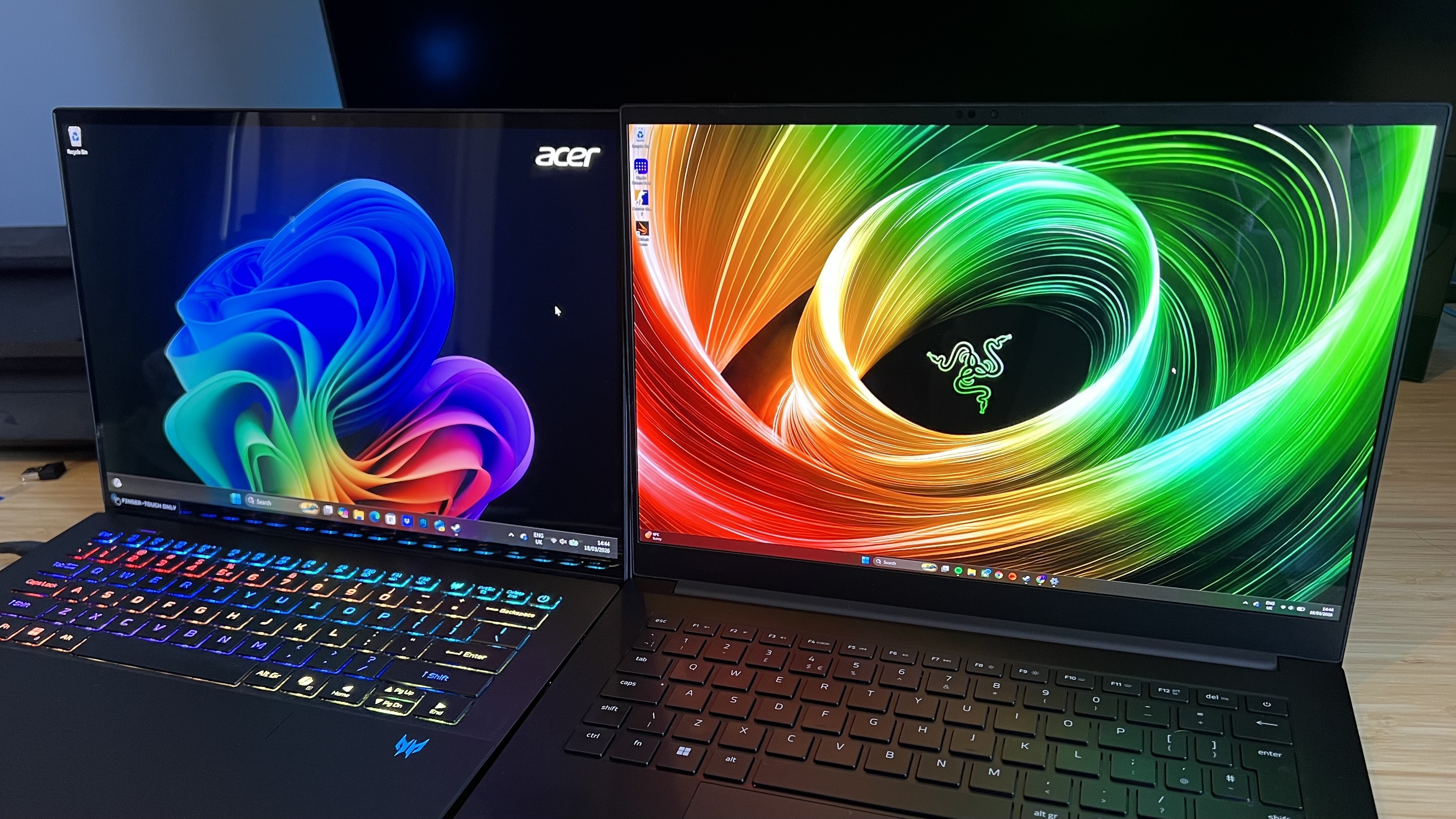 Razer Blade 14 and Acer Predator Triton 14 AI gaming laptop displays side by side on home screen