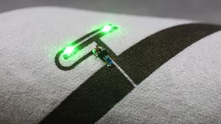 Powercast's Liquid X conductive ink in close up with two green LEDs showing