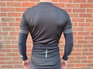 Rear view of a male cyclist wearing the Pinnacle Race SS jersey