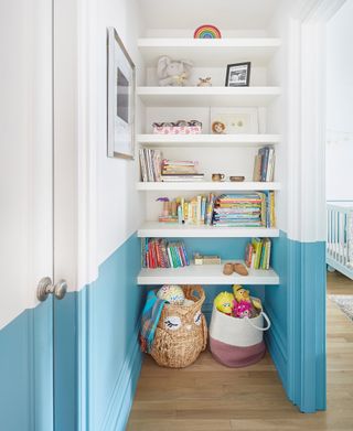 A blue and white storage area with open shelves