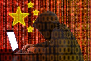 Hacker on a computer with a Chinese flag in the background