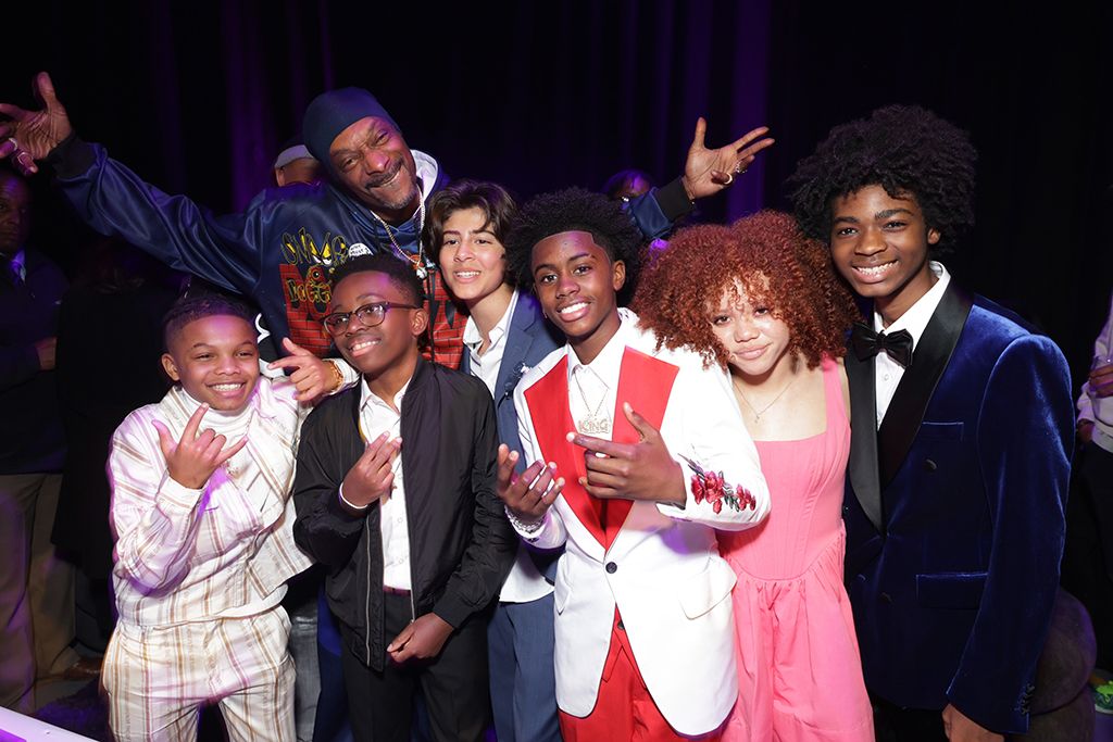 Snoop Dogg (rear) and (front, l. to r.) Jonigan Booth, Alexander Gordon, Adan James Carrillo, Caleb Dixon, Kylah Davila and Shamori Washington at the world premiere afterparty for Prime Video&rsquo;s The Underdoggs at The Culver Studios in Culver City, Calif.