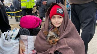 Girl wrapped in blanket with her dog