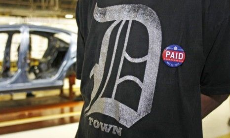 A Chrysler assembly worker sports a pin