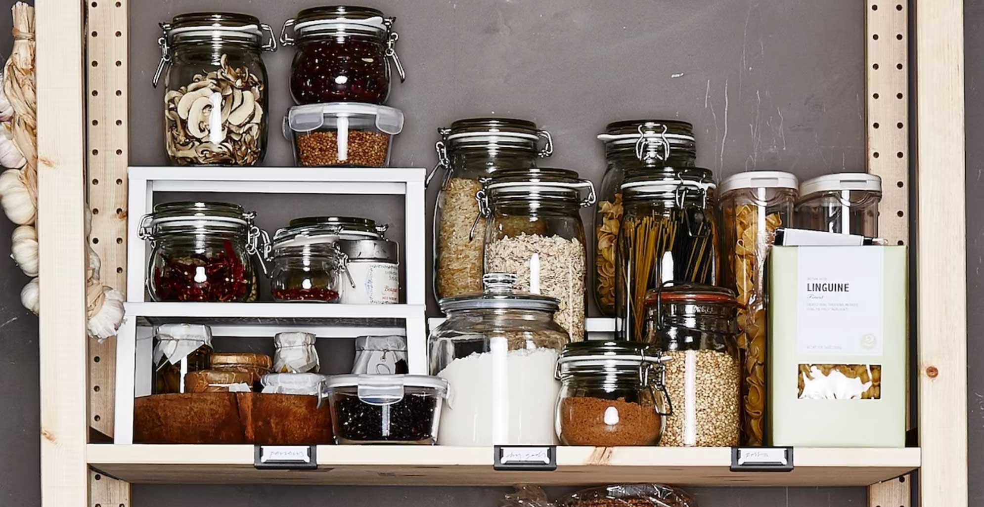 Inside an organized pantry with shelf stackers to show how to maximize space on the shelves
