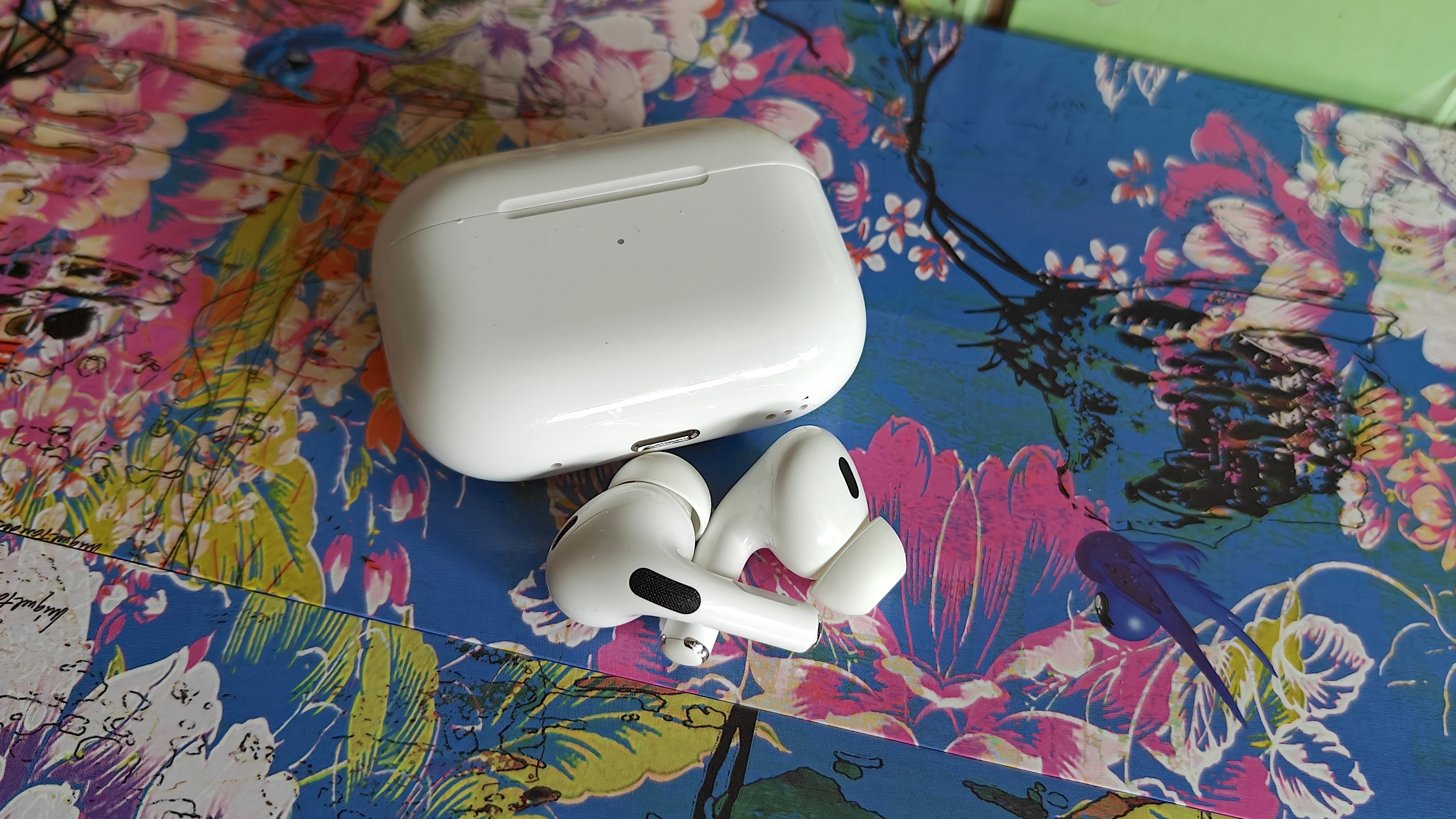 The AirPods Pro 2 displayed on a colorful background