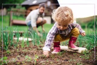 a young boy looking for bugs in the soil as part of a fun earth day activity for kids