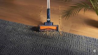 The Shark PowerDetect Speed IA1241UK cleaning up a messy floor.