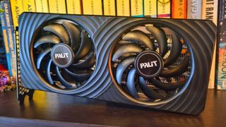 A Palit GeForce RTX 5060 Ti 8 GB Dual graphics card on a bookshelf