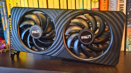 A Palit GeForce RTX 5060 Ti 8 GB Dual graphics card on a bookshelf