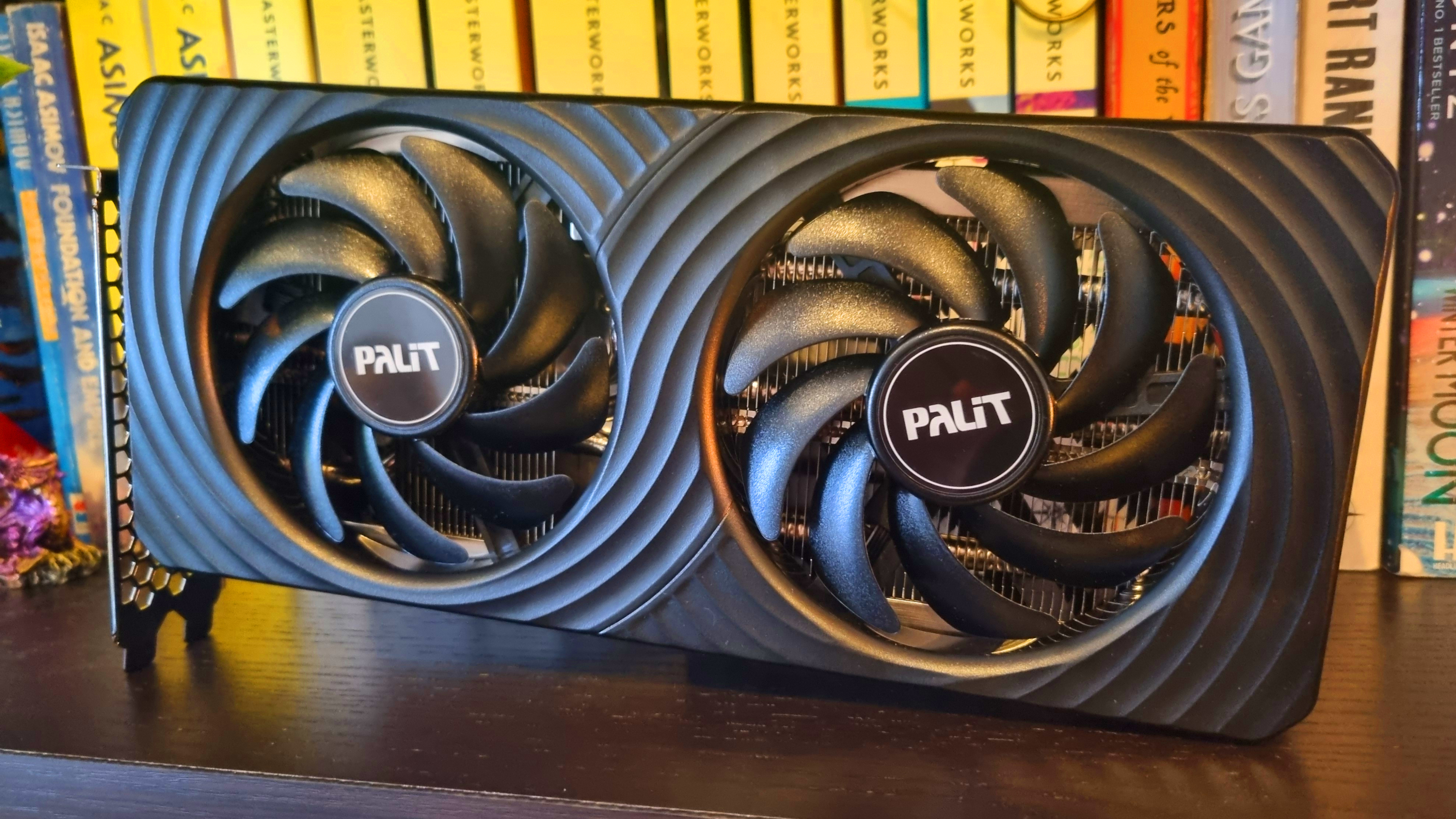 A Palit GeForce RTX 5060 Ti 8 GB Dual graphics card on a bookshelf
