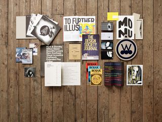 A spread of creative work with magazines , cards and pictures