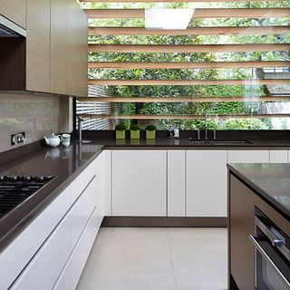 kitchen with wooden louvres shade the window and kitchen sink