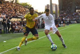 Arsenal's Joe Willock and Angers' Rachid Alioui compete for the ball in a pre-season friendly in July 2019.