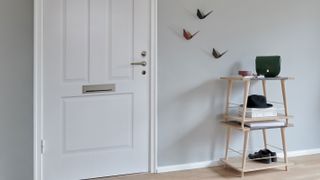 grey living room with narrow skirting and birds on wall