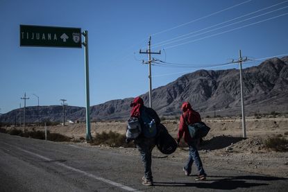 Migrants walk toward Tijuana.