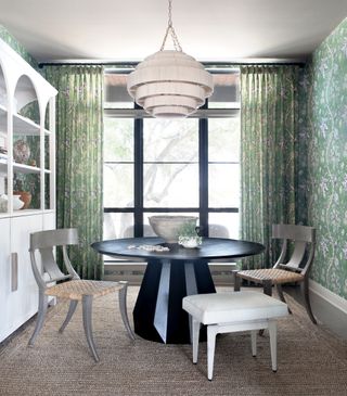 Dining room with green patterned wallpaper matching the curtains